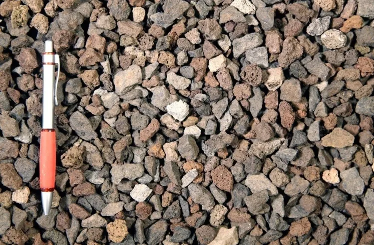 Poromax Lava van dichtbij: poreuze lavasteentjes, met een pen ernaast voor de grootte